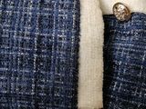 a close up of a blue jacket with a button on it
