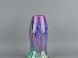 a close up of a vase with a purple and green design on it