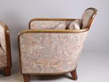 pair of upholstered armchairs with upholstered back and arms