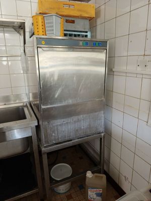 an image of a kitchen with a sink and a metal cabinet