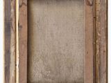 an old wooden frame with a label on it and a white background