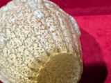 a close up of a baseball cap on a red surface