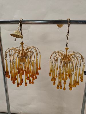 a pair of earrings that are hanging from a rack