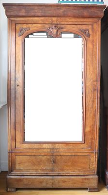 a large mirror sitting on top of a wooden cabinet