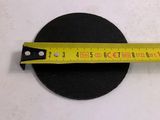 the measuring tape is on top of a round black object