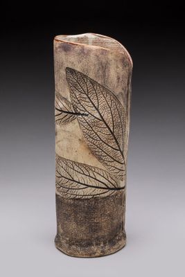 an image of a tall vase with a leaf design on it