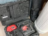 two tools in a case on the floor next to a trash can