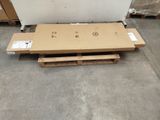 a box of cardboard sitting on top of a pallet in a warehouse