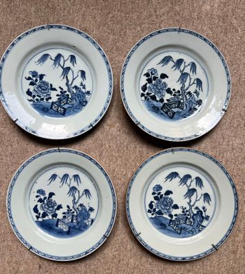 quatre assiettes bleues et blanches ornées d'oiseaux et de fleurs