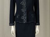 a mannequin dressed woman wearing a skirt suit and jacket