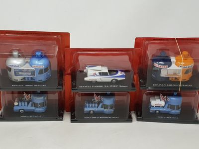 three boxed boxed toy vehicles in plastic cases on a white surface