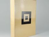 side view of a book showing the cover in gold