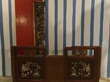 a wooden cabinet with a mirror on top of it in front of a blue and white striped wall