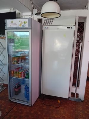 a white refrigerator and a pink refrigerator freezer in a room