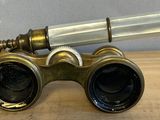 a small telescope that is sitting on a wooden table