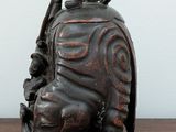a small figurine of a man sitting on top of a wooden table