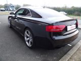 a black audi car parked in a parking lot