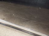 a metal door with a handle on it in a room