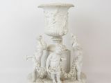 a white vase sitting on a pedestal with a bird on it