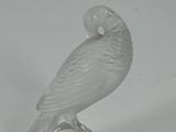 an image of a glass figurine of a bird on a stand