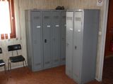 two lockers in a room with a chair in front of them
