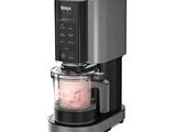 a black and silver coffee maker with a blender on it