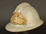 a white helmet with a gold emblem on it