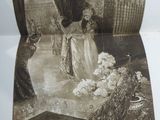 an old picture of a woman standing in front of a fountain