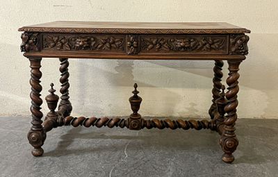 a wooden table with a carved top on the floor