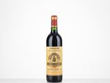 a bottle of red wine sitting on top of a table