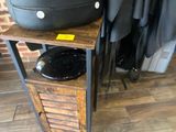 a black suitcase sitting on top of a wooden table