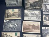 several old black and white photographs of people and buildings on a table