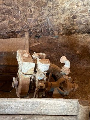 an old machine that is sitting in the dirt