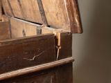 a wooden chest with a carved design on it