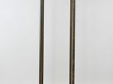 an antique brass and glass floor lamp with a white shade