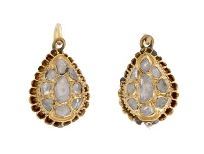 an image of a pair of earrings with a tear shaped stone