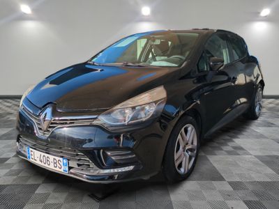 a black car is parked in a room with a checkered floor