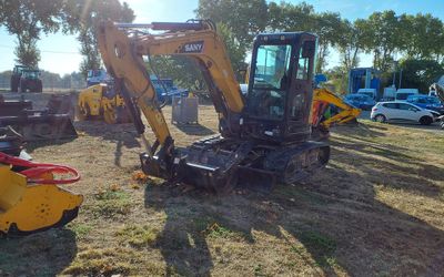 a picture of a tractor and other machinery in a field