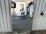 a reflection of a bike in a mirror on the side of a building