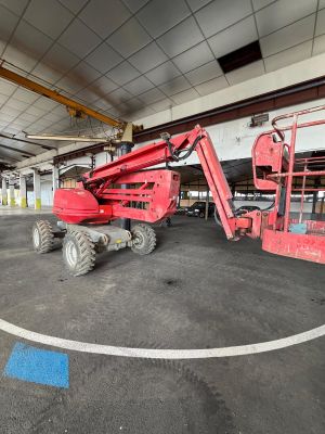 a red lift truck parked inside of a building