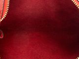 a red purse that is open on a white surface