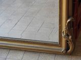 a mirror that is sitting on the floor in front of a wall