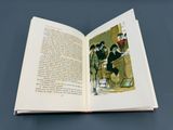 un livre ouvert sur lequel figure l'image d'un homme et d'une femme assis à une table