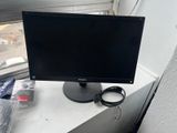 a computer monitor sitting on top of a window sill