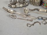 a table with silverware and silver spoons on it