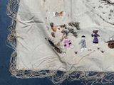 a piece of cloth with a picture of people and animals on it