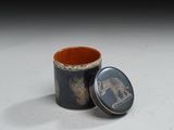 a small tin with an elephant design on it