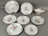 a group of plates and bowls with flowers on them