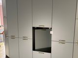 a kitchen that has a stove and cabinets in it