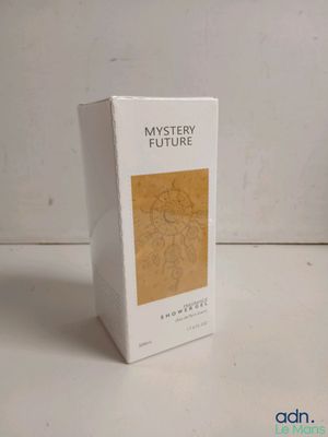 a box of perfume sitting on a table next to a bottle of perfume